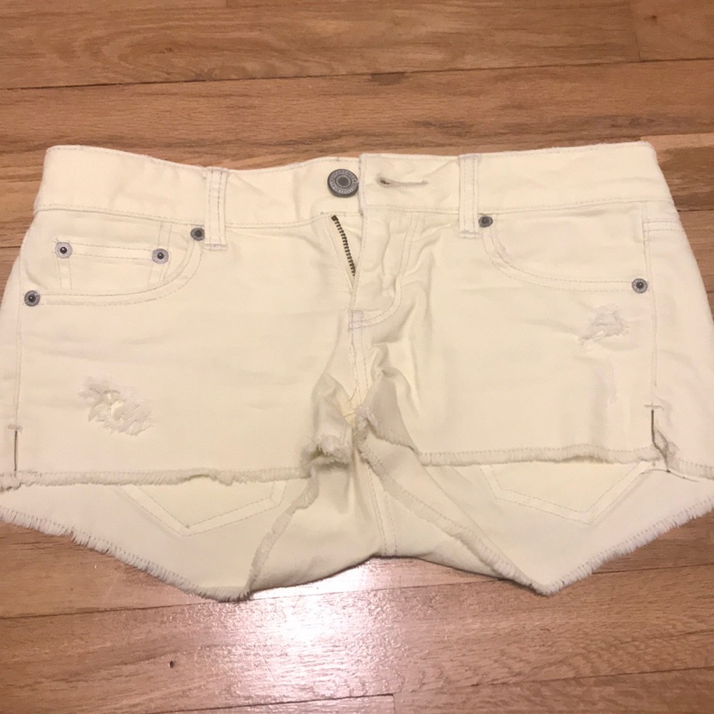 Light yellow ripped jean shorts
